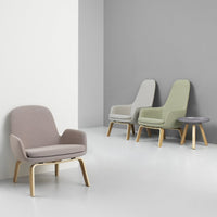 Chic armchairs in muted lavender, soft green, and light gray with wooden legs, perfect for modern decor.