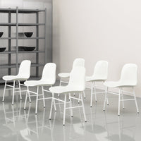 Set of six modern white chairs with sleek lines, standing on a glossy gray floor with minimalist shelving in the background.