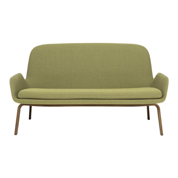 Green mid-century modern sofa with a smooth, textured fabric and sleek wooden legs. Ideal for stylish living spaces.