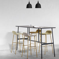 "Modern bar table in gray with four pastel-colored stools in cream, light gray, muted green, and gold accents."