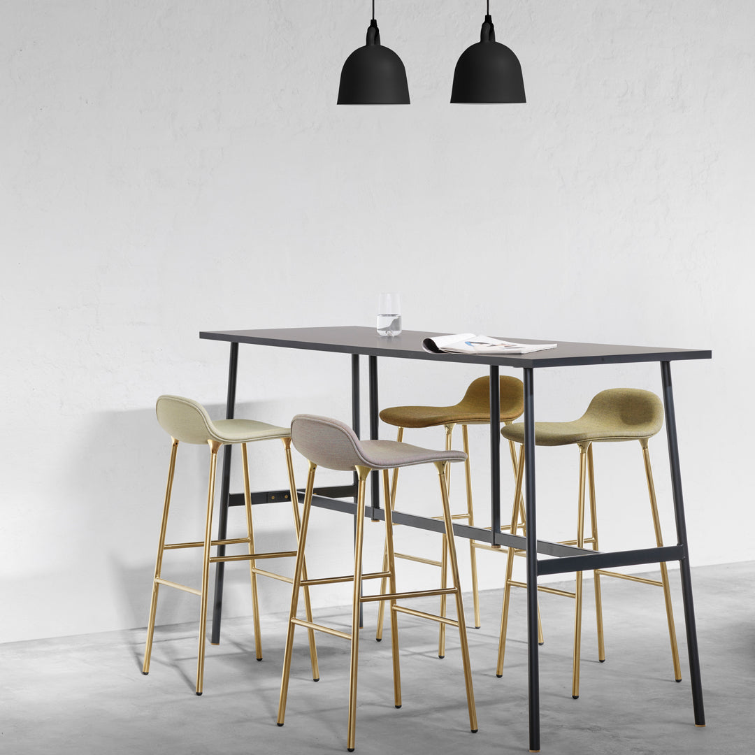 "Modern bar table in gray with four pastel-colored stools in cream, light gray, muted green, and gold accents."