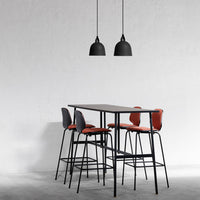 Stylish black bar table with gray and rust-colored upholstered chairs, set against a minimalist white backdrop.