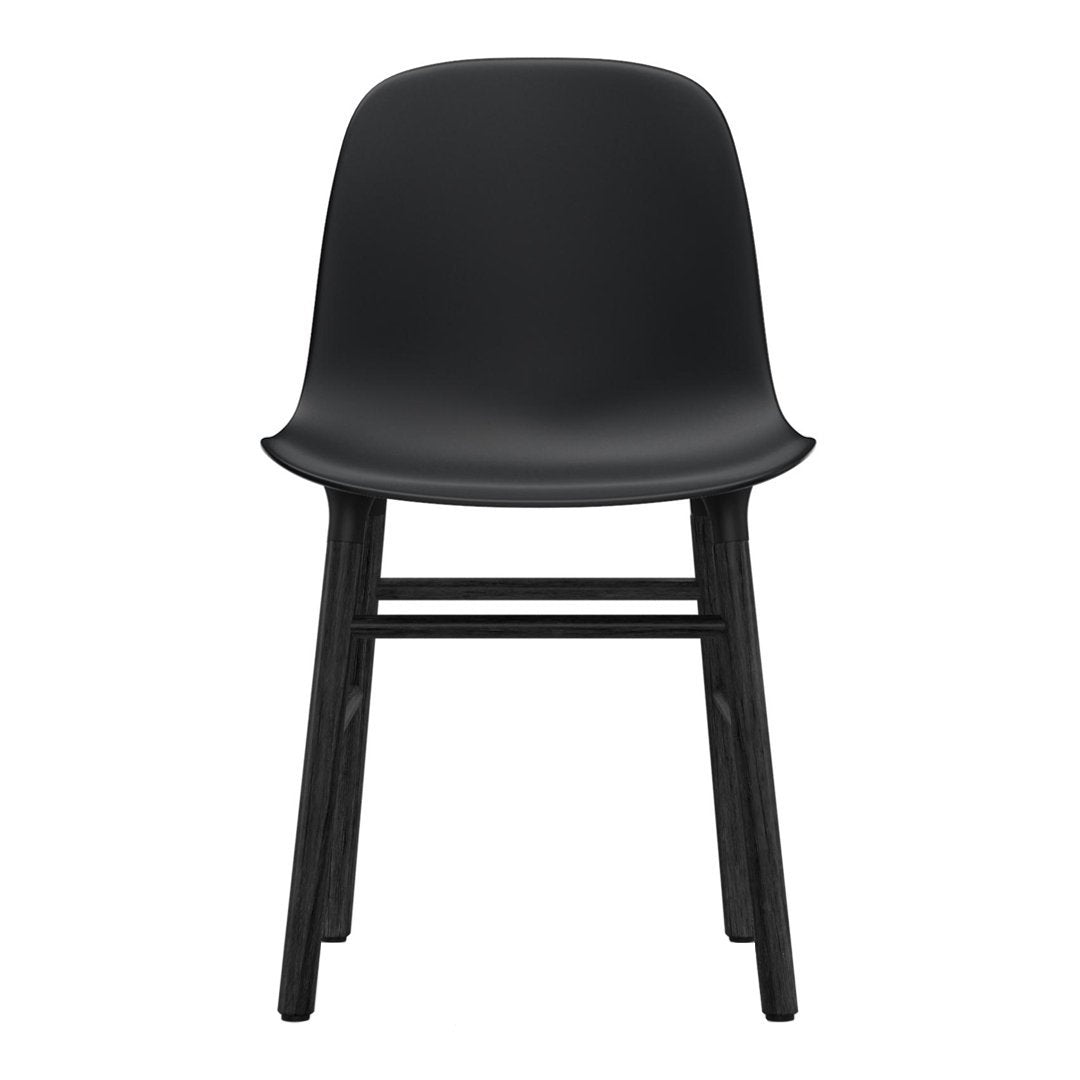 Minimalist black chair with a sleek seat and natural wood legs, emphasizing modern design and clean lines.
