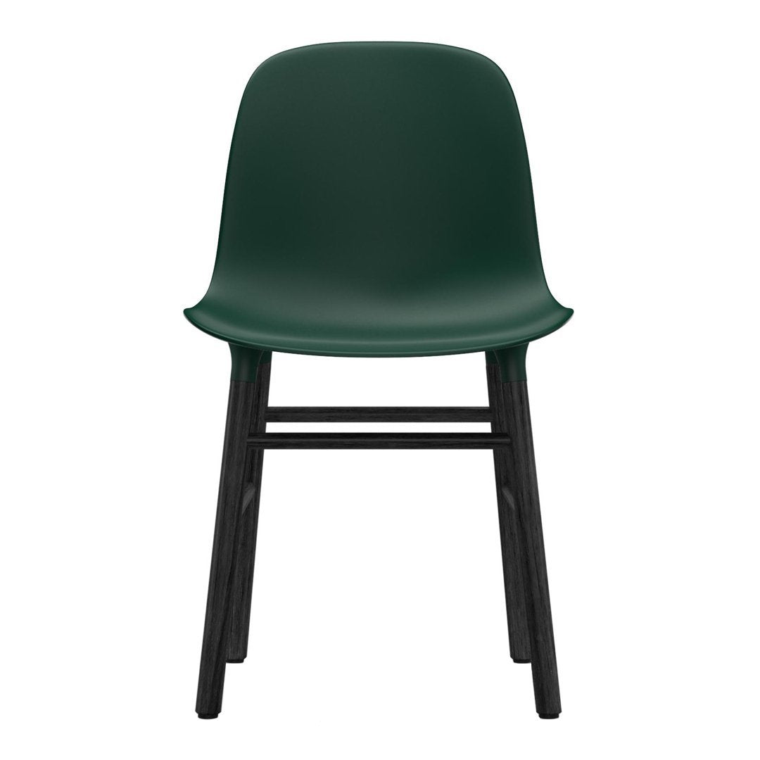 Green plastic chair with a smooth finish and sleek black wooden legs. Modern, minimalist design.