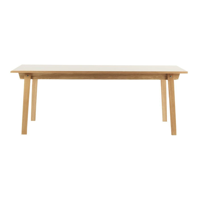 Light wood dining table with a smooth, natural finish and clean lines, perfect for modern interiors.