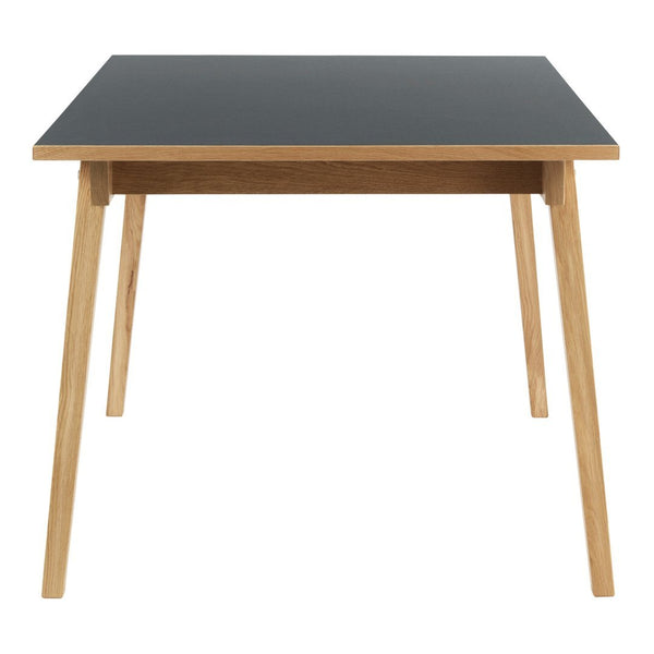 Black tabletop with natural wood legs, minimalist design, perfect for modern decor.