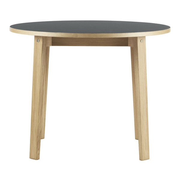 Round table with a black top and natural wood legs, featuring a sleek, modern design. Perfect for any space.