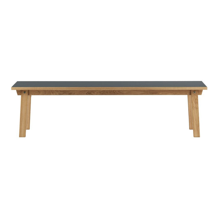 Natural wood bench with a sleek black top, featuring a simple, modern design and clean lines.