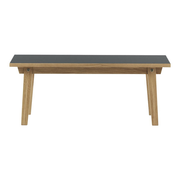 Stylish black tabletop with natural wood grain legs, showcasing a modern and minimalist design. Perfect for any space.