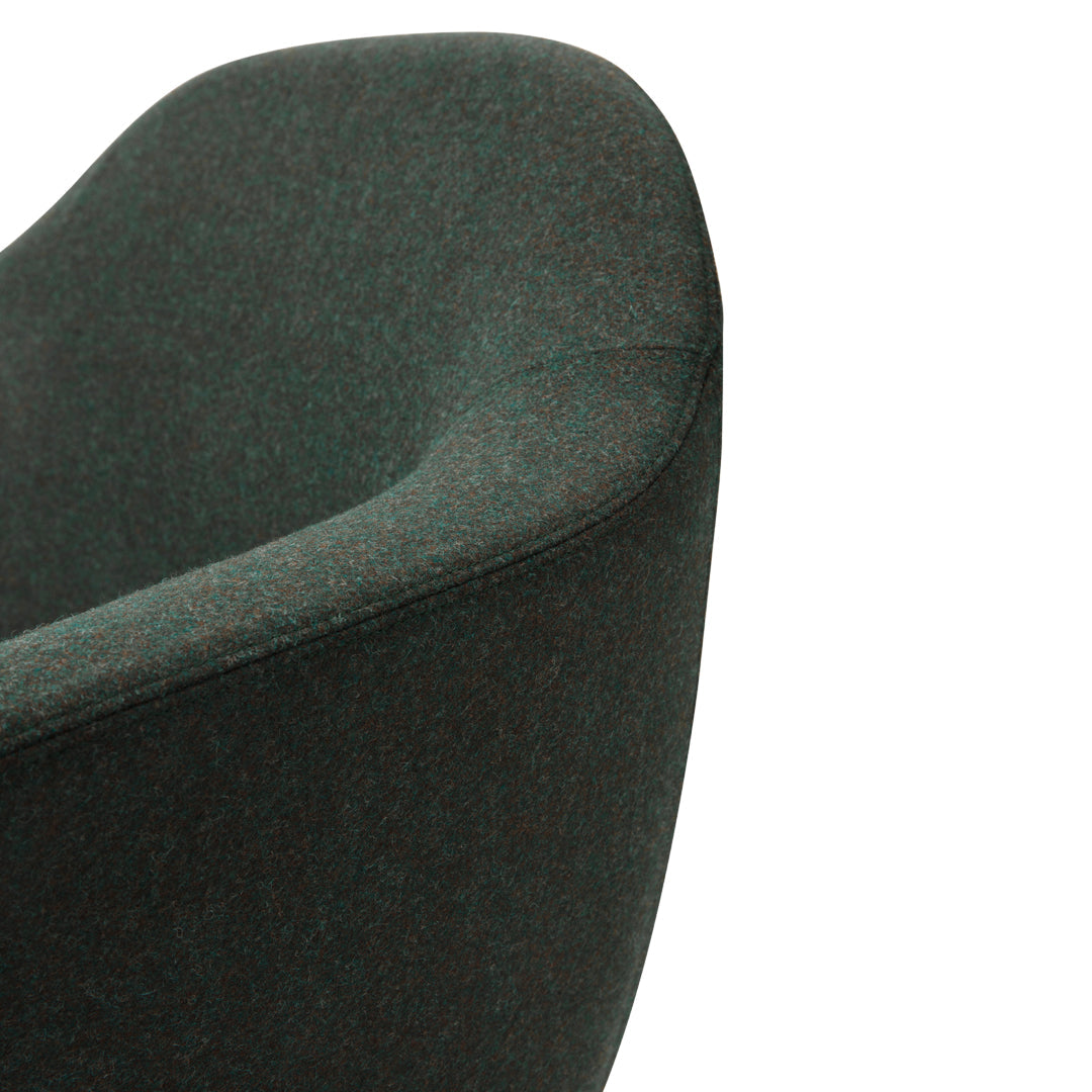 Textured dark green chair with a smooth, curvy silhouette, featuring rich, deep hues for a modern aesthetic.