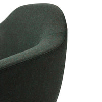 Textured dark green chair with a smooth, curvy silhouette, featuring rich, deep hues for a modern aesthetic.