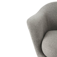 Gray upholstered chair with soft, textured fabric and smooth, rounded contours. Perfect for modern interiors.