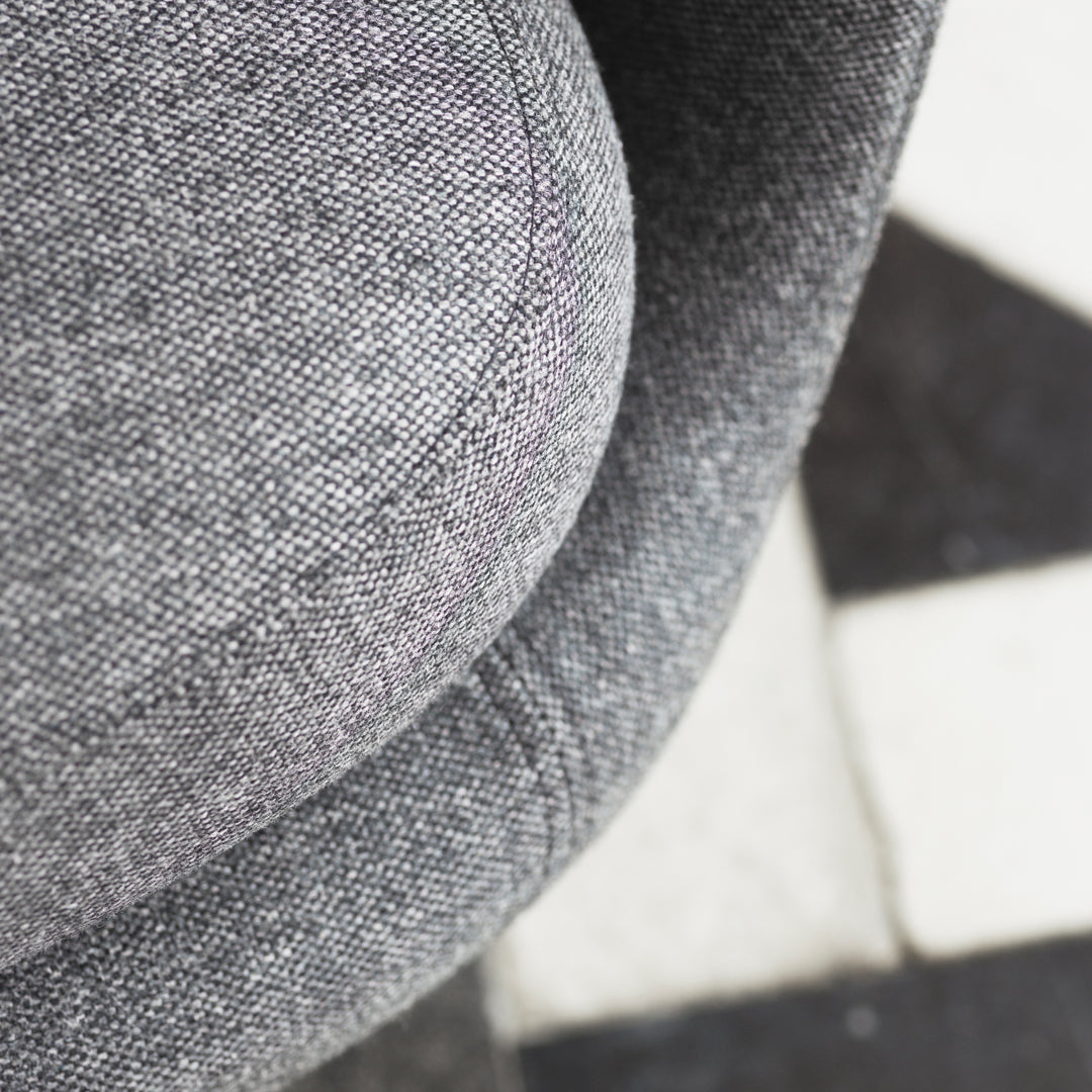 Gray textured fabric with a smooth, rounded design, featuring subtle patterns and a modern aesthetic.