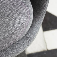 Gray textured fabric with a smooth, rounded design, featuring subtle patterns and a modern aesthetic.