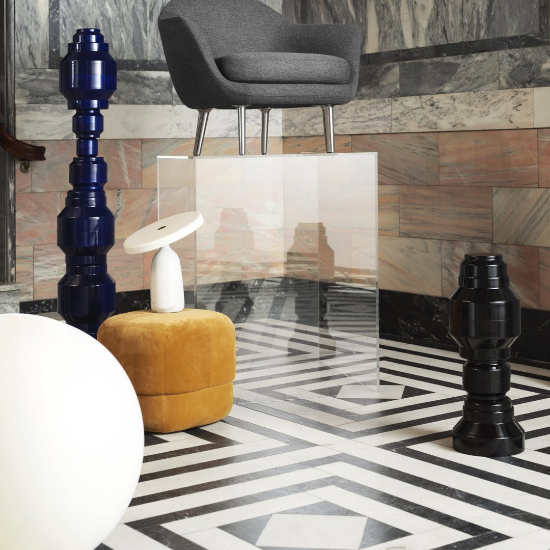 Modern decor featuring black and white geometric floor pattern with blue, gray, yellow, and white accent pieces.