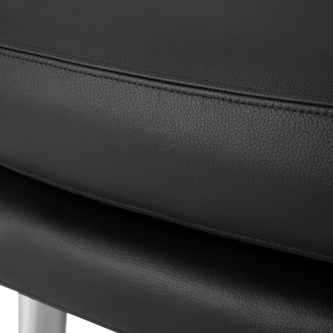 Close-up of smooth black leather upholstery with subtle texture and stitching details, highlighting a modern design.