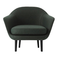 Green upholstered chair with a smooth, curved design and black legs, perfect for modern living spaces.