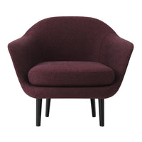 Plush burgundy armchair with a sleek, minimalist design and black legs, perfect for modern interiors.