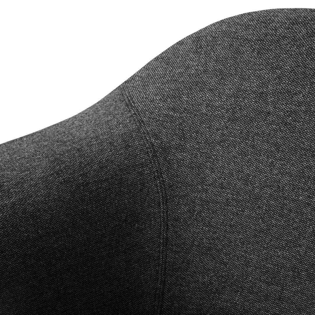 Close-up of textured dark gray fabric with smooth contours and subtle stitching details. Perfect for modern styles.