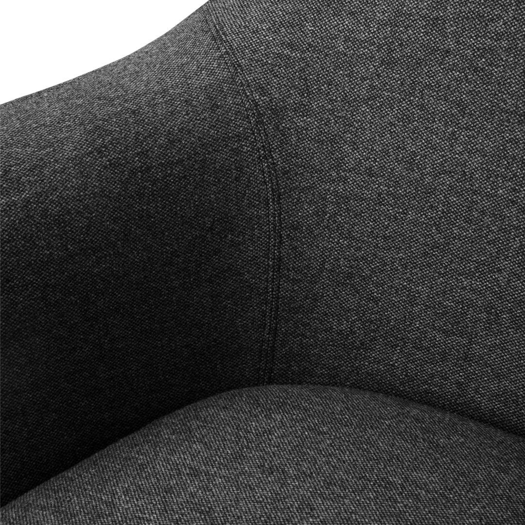 Dark gray textured fabric showcasing a subtle heathered pattern on a modern chair.