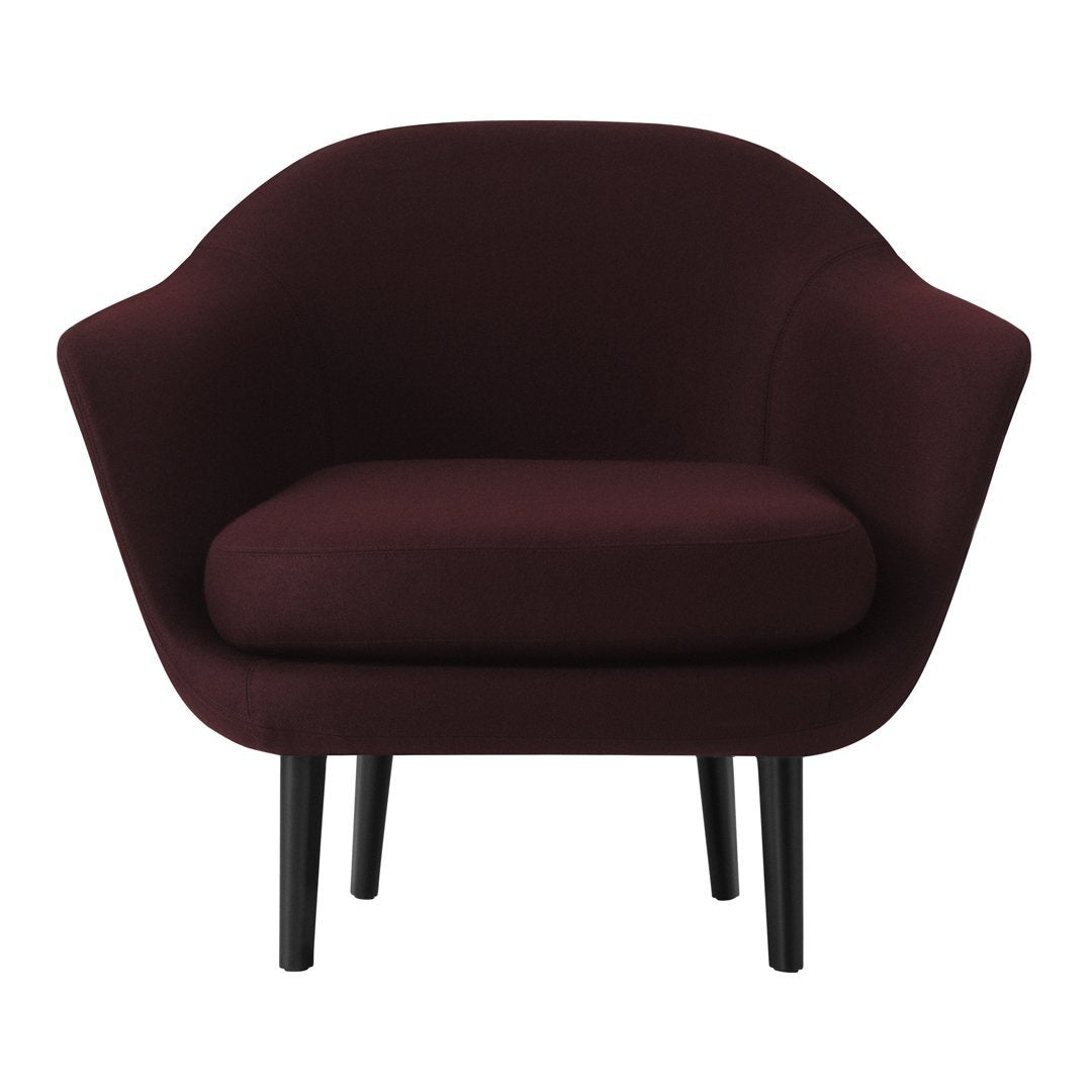 Burgundy upholstered accent chair with smooth curves and black tapered legs. Ideal for modern interiors.
