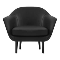 Short black accent chair with smooth fabric and rounded curves. Sleek black legs enhance modern aesthetic.
