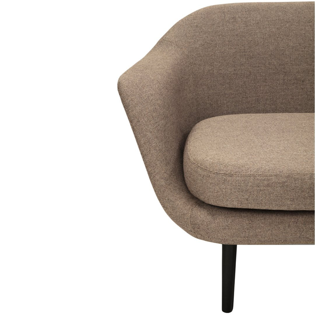 Curved brown fabric upholstery couch with a smooth texture and sleek black legs. Modern minimalist design.