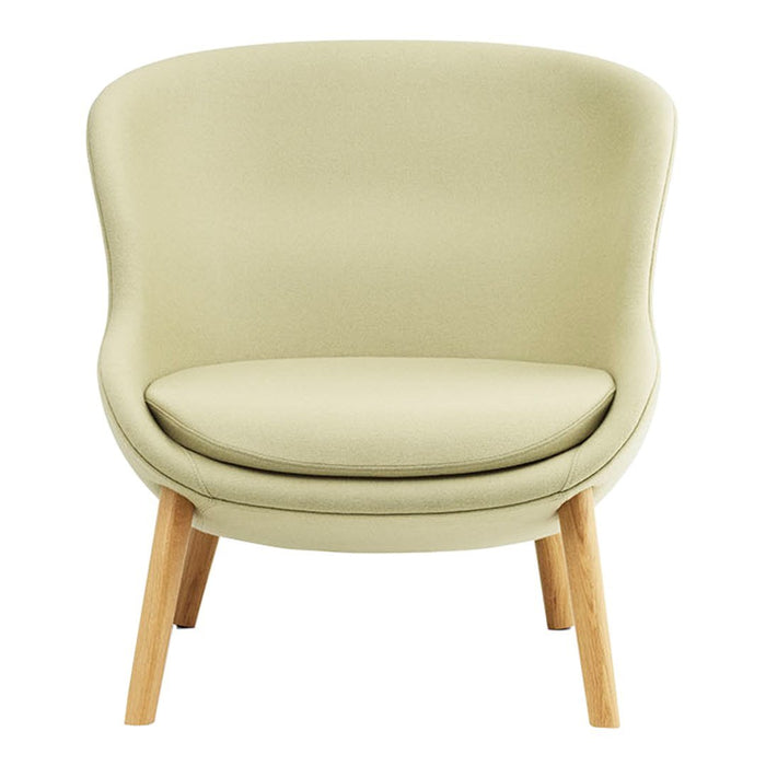 Light green upholstered chair with smooth curves and natural wood legs, perfect for modern decor.