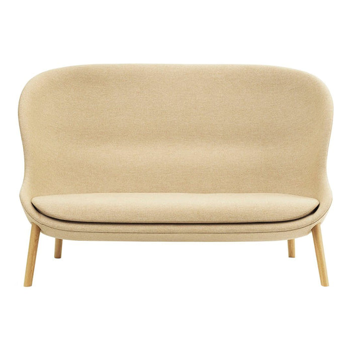 Elegant beige sofa with smooth curves and natural wood legs, perfect for modern living spaces.