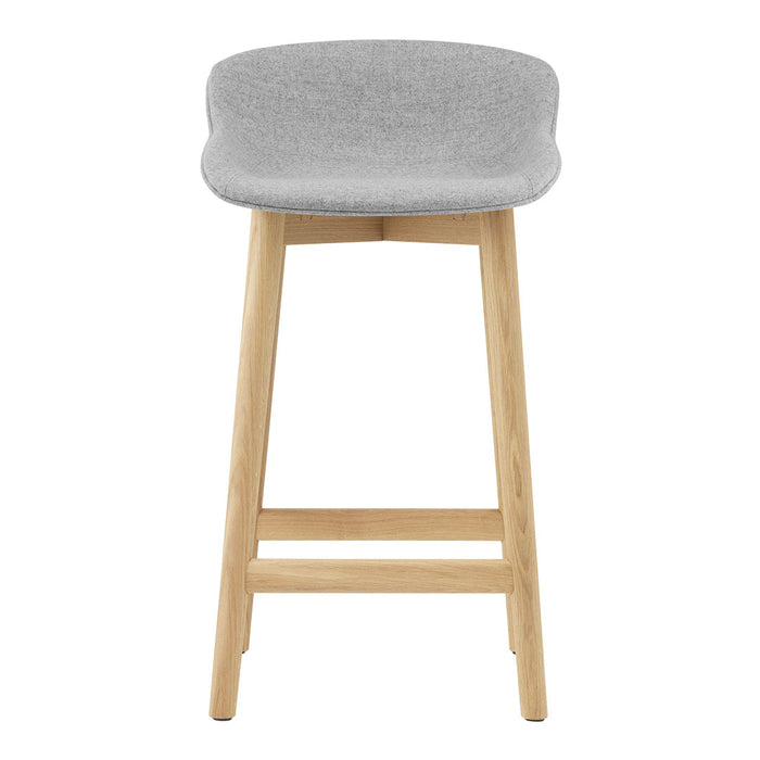 Gray upholstered bar stool with a smooth finish and natural wood legs, perfect for modern interiors.