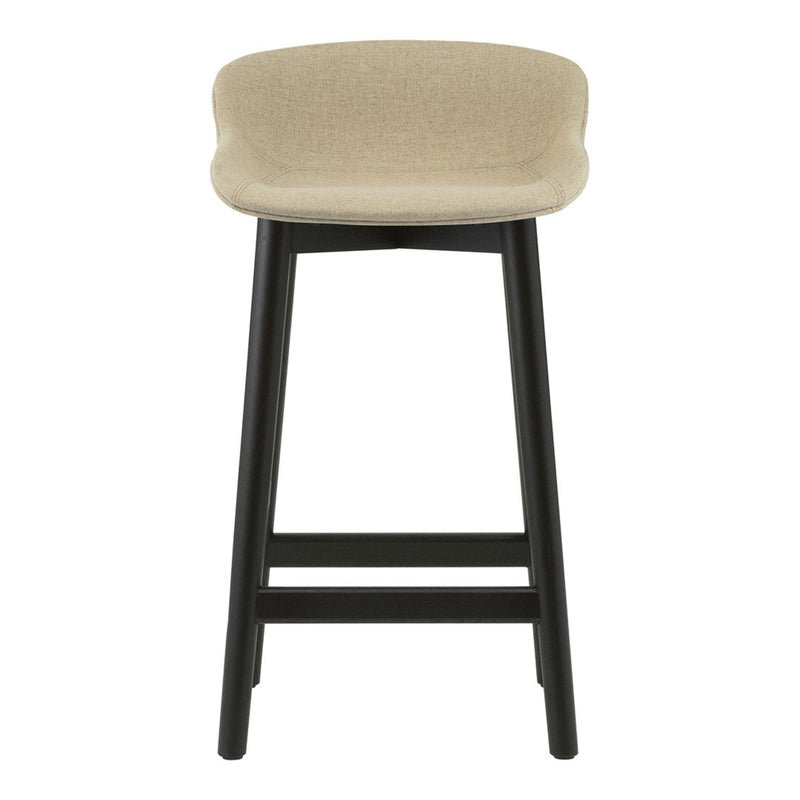 Beige upholstered stool with a smooth surface and sleek black wooden legs, creating a modern contrast.