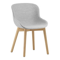 Gray upholstered chair with smooth, curved design and light wood legs. Minimalist style for modern decor.