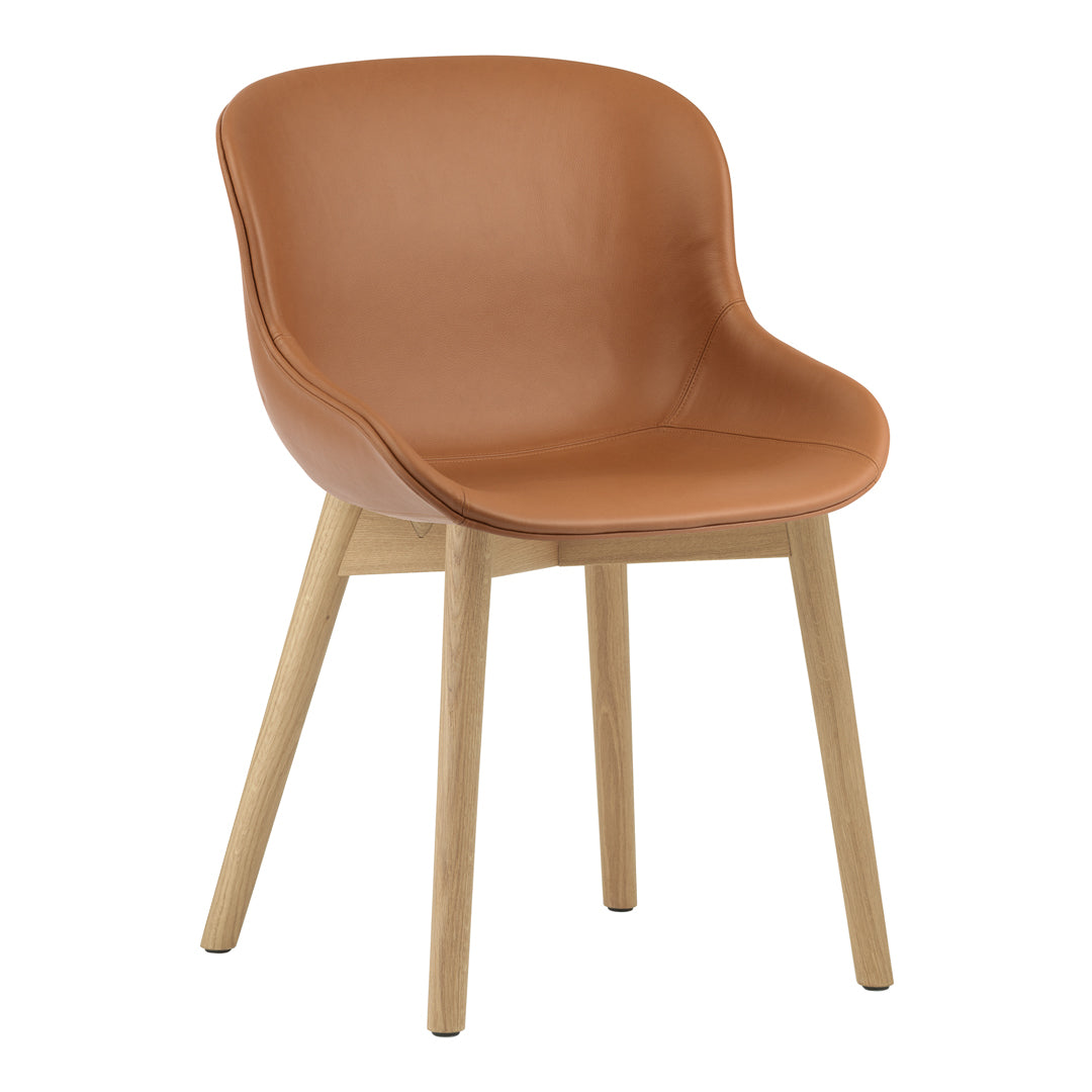 Tan upholstered chair with smooth curves and natural wood legs, perfect for modern home decor.