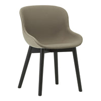Sleek beige upholstered chair with a smooth, minimalist design and contrasting black wooden legs.
