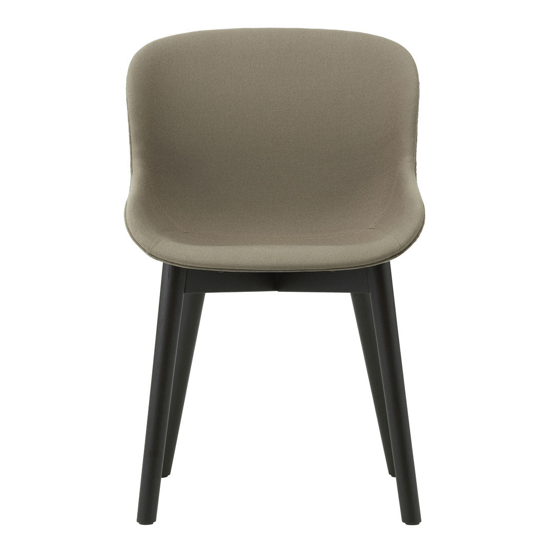 Modern chair in soft taupe upholstery with sleek black legs, showcasing a minimalist design and smooth curves.