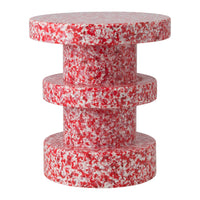 Red and white speckled accent table featuring a cylindrical, stacked design. Perfect for modern decor.