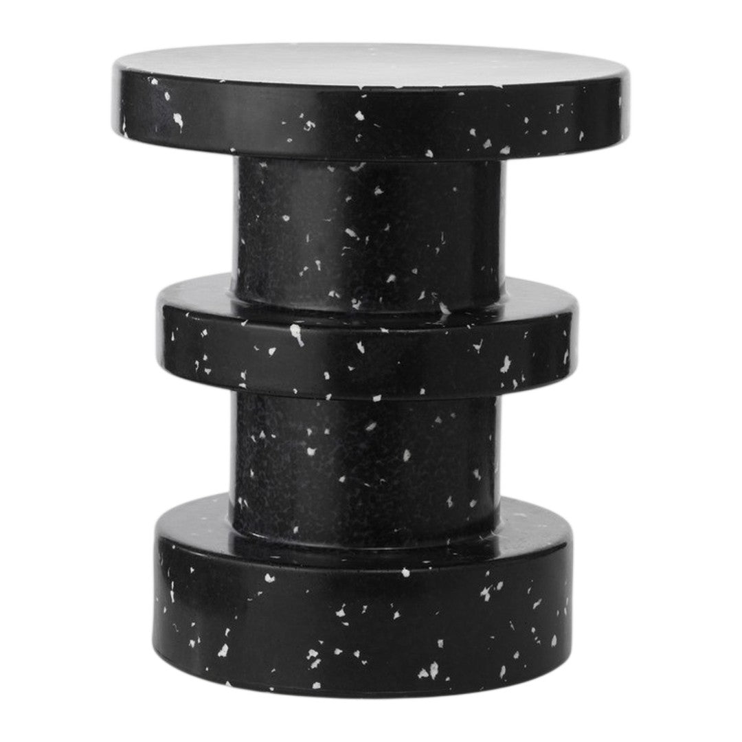Black speckled side table with a modern, cylindrical design and smooth, glossy surface. Perfect for contemporary spaces.
