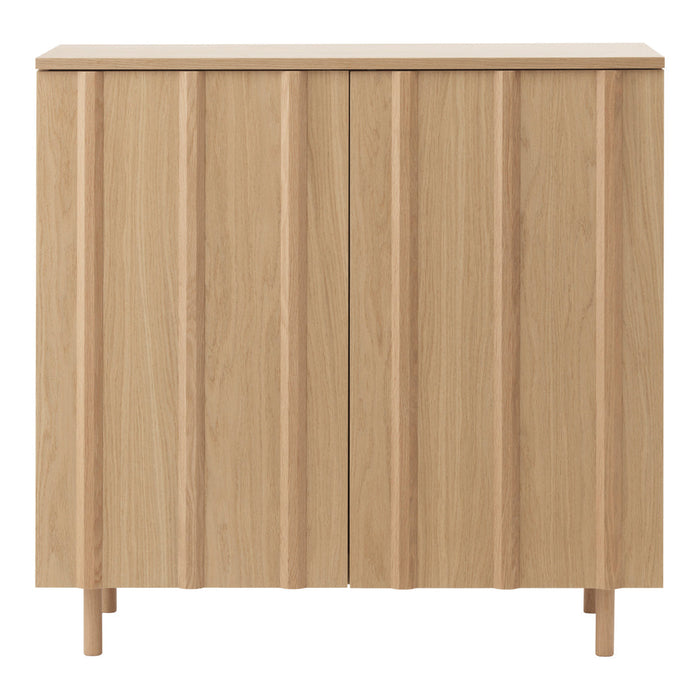 Light oak cabinet with vertical grooves and a minimalist design, perfect for modern interiors.