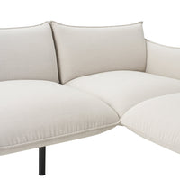 Cream-colored fabric sectional sofa with soft, smooth cushions and minimalist design. Perfect for modern interiors.