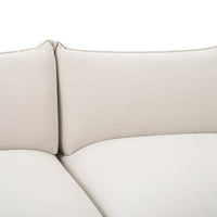 Light beige couch cushions with a smooth, textured fabric pattern, ideal for modern decor.