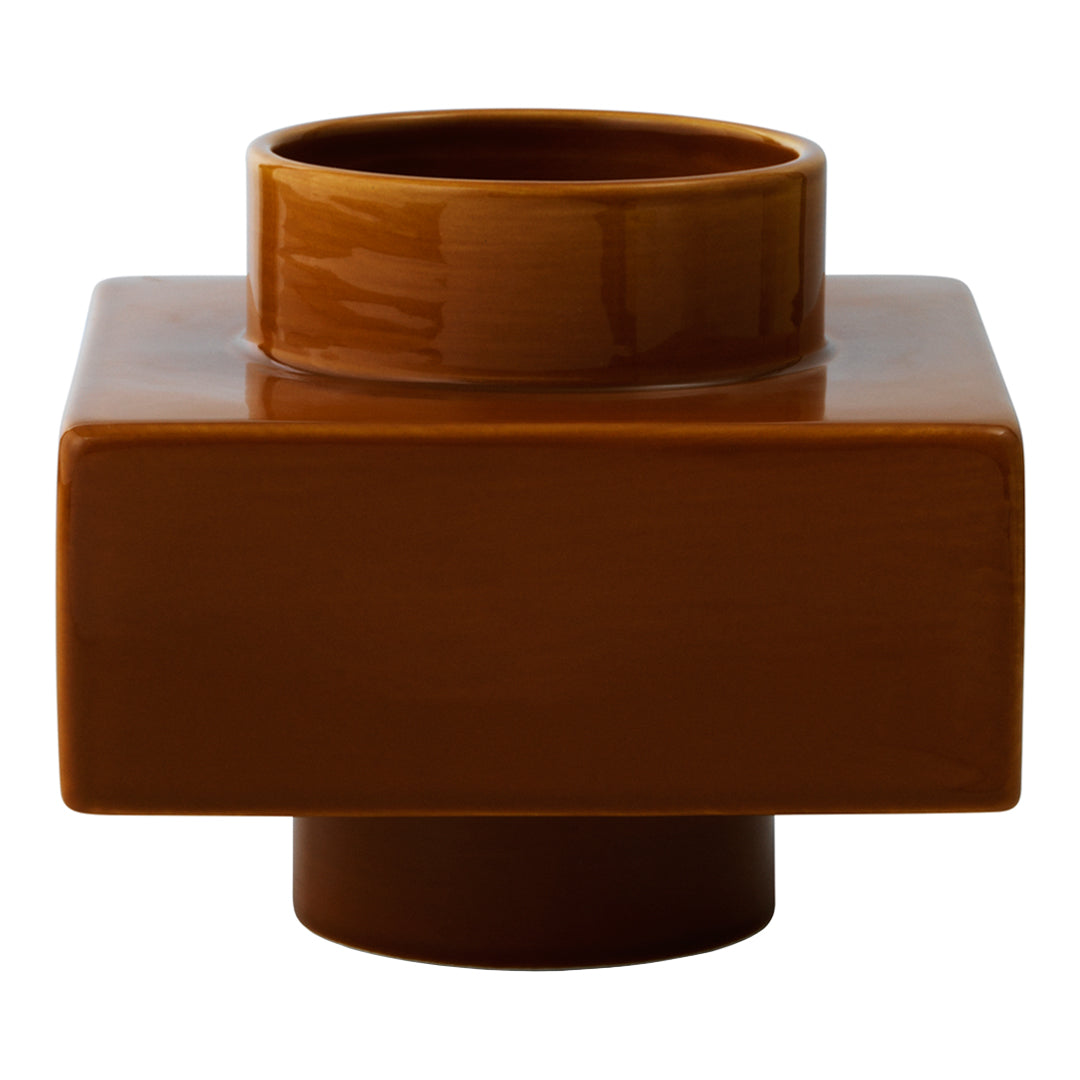 Brown ceramic vase with a glossy finish and geometric square design, featuring a smaller circular opening on top.