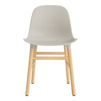 Light gray plastic chair with natural wood legs, minimalistic design, and smooth, clean lines. Ideal for modern decor.
