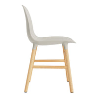 Sleek gray chair with a smooth surface and natural wooden legs, combining modern and minimalist design.