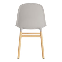 Gray chair with a smooth, curved back and natural wood legs, showcasing a minimalist design.