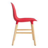 Red molded plastic chair with natural wood legs, sleek design and smooth curves. Ideal for modern interiors.