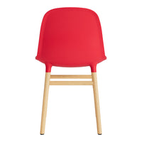 Bright red chair with a smooth surface and natural wood legs, perfect for modern decor.