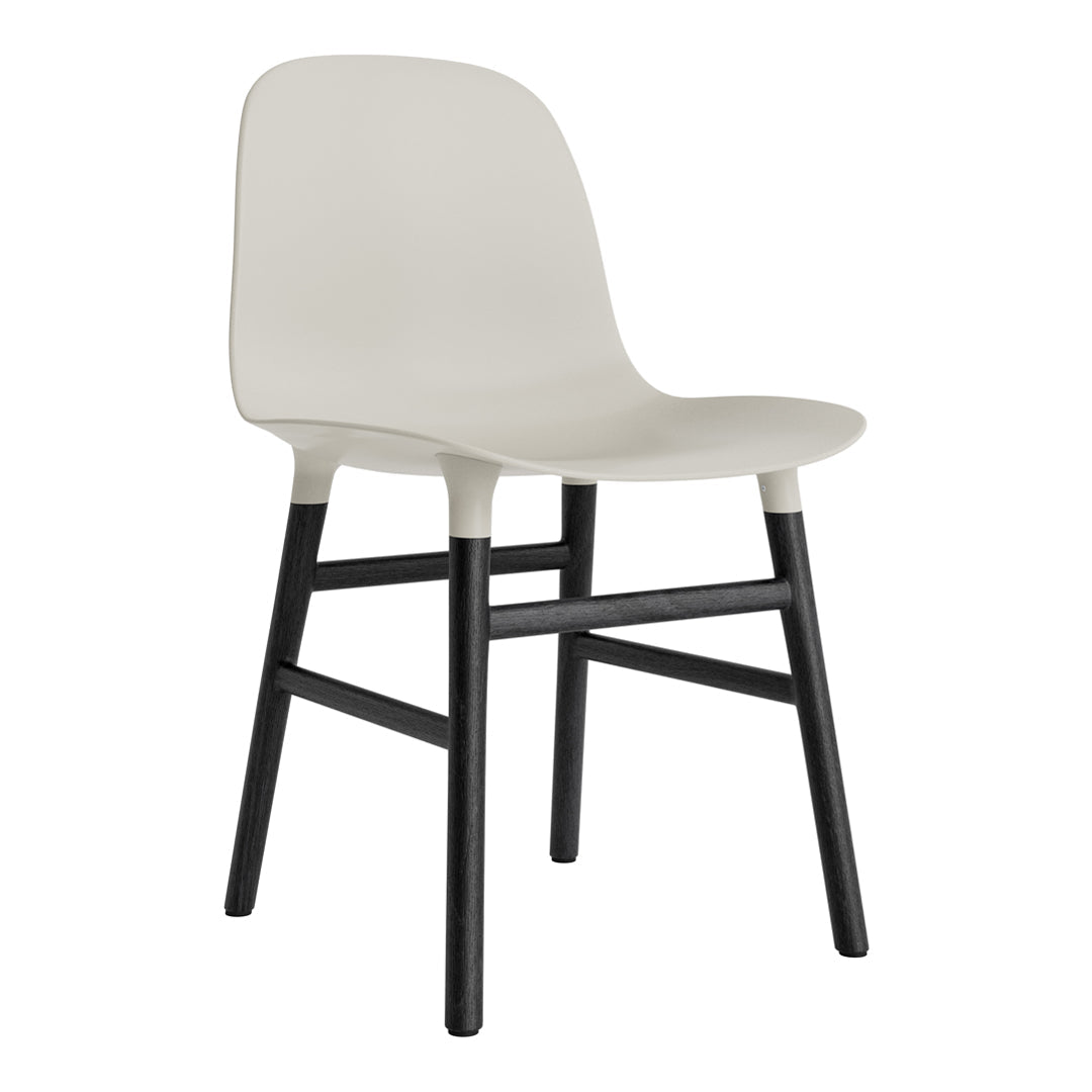 Modern beige chair with a smooth finish and contrasting black wooden legs, perfect for any contemporary space.
