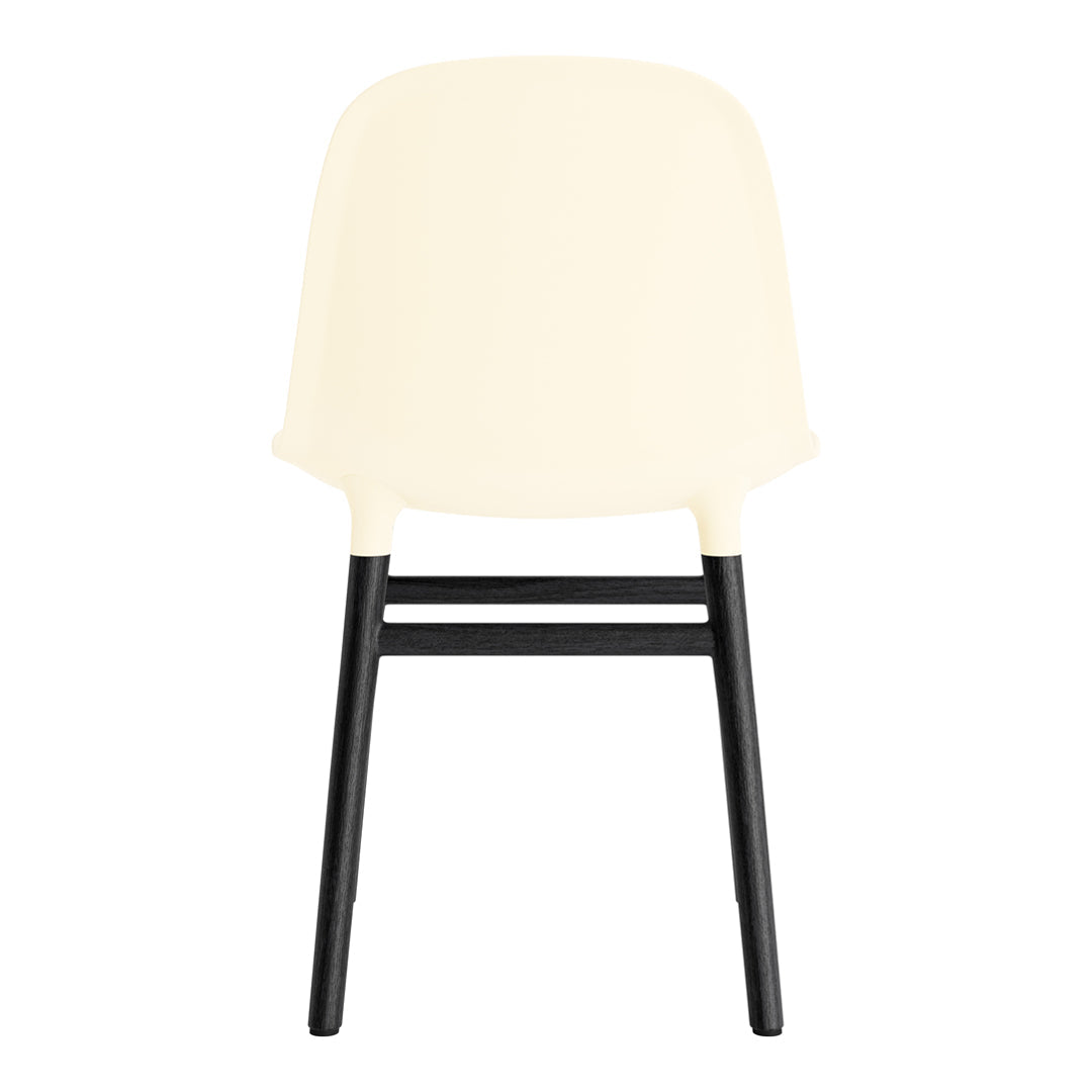 Ivory chair with a smooth, minimalist design and contrasting black wooden legs. Modern and stylish look.