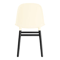 Ivory chair with a smooth, minimalist design and contrasting black wooden legs. Modern and stylish look.