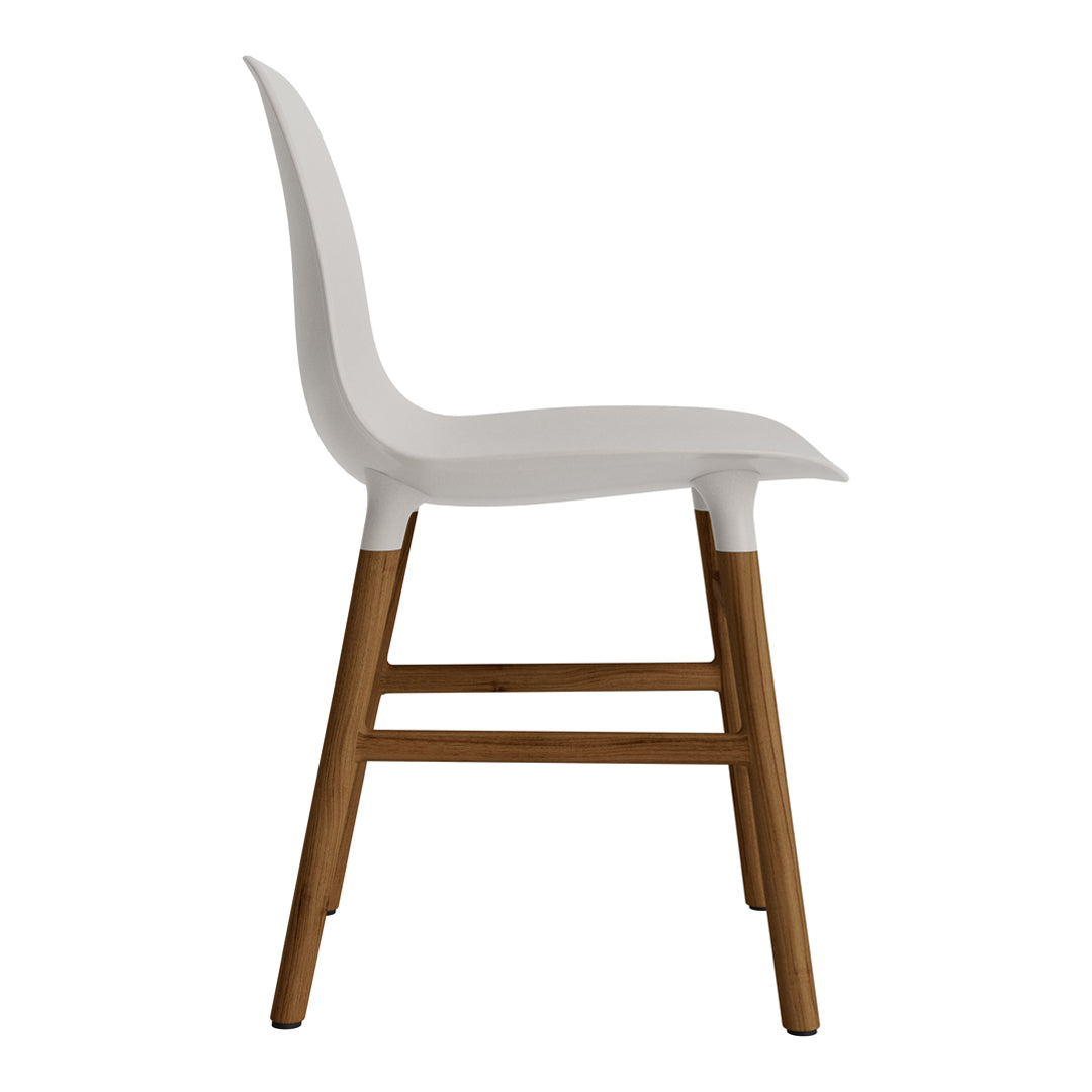 White chair with a smooth, minimalist design and natural wood legs. Simple, modern aesthetic.